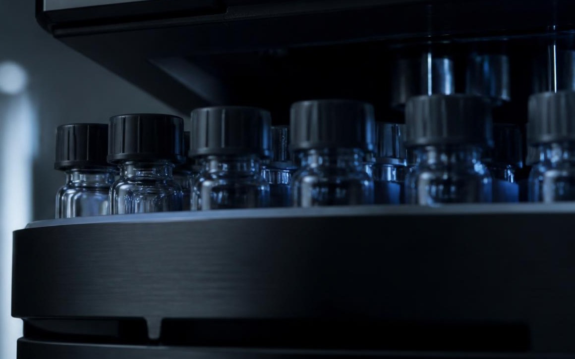 Sealed sample vials seated in the autosampler tray of a high-performance liquid chromatograph